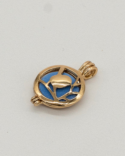 Gold Scent Locket with an intricate openwork design revealing a blue insert, crafted in polished gold-tone metal for an elegant aromatherapy necklace accessory.