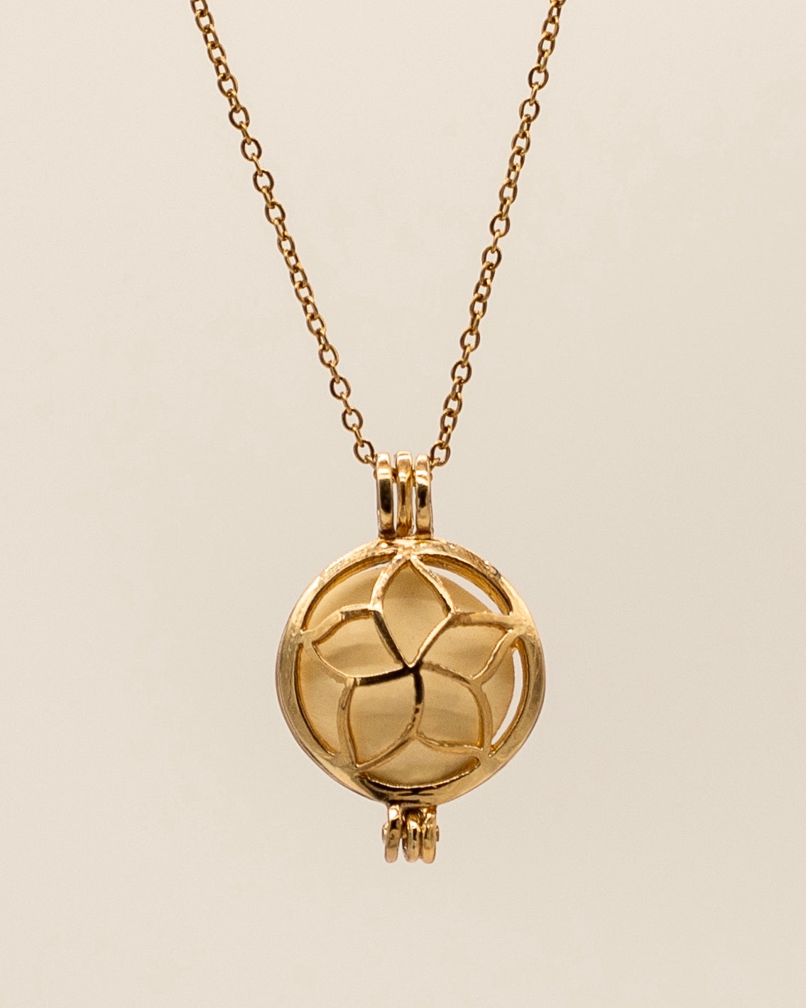 Gold Scent Locket necklace with an elegant floral design in a polished gold-tone finish, perfect for wearing your favorite aromatherapy essential oils.