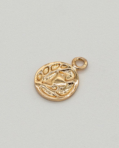 Small gold charm with textured abstract design and loop for attaching, part of the Charm Bracelet collection.
