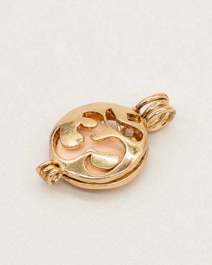 Gold Scent Locket in polished gold finish with intricate cut-out design, featuring a soft pink insert for holding fragrance, perfect for aromatherapy use.