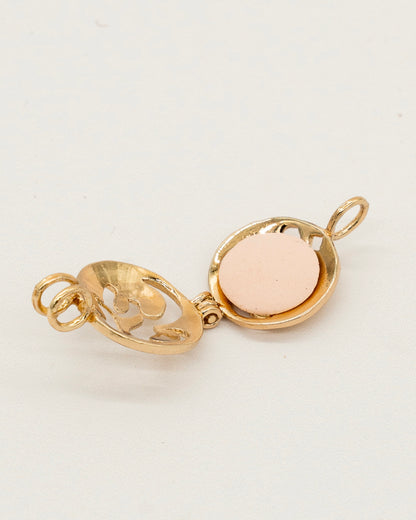 Gold Scent Locket open to show a round aromatic pad inside, stylish gold-tone metal with delicate cutout floral design for aromatherapy use.