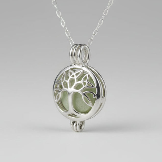 Silver tree of life pendant on a chain with a natural background