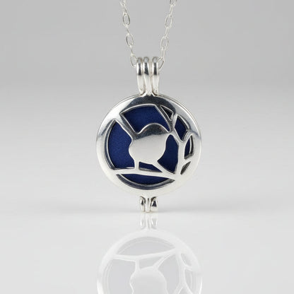 Silver locket with blue interior on a white background